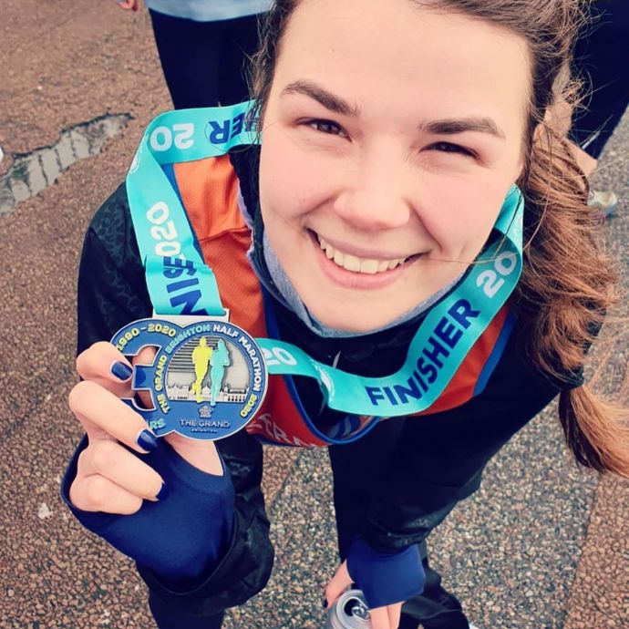 Half marathon runner with her medal