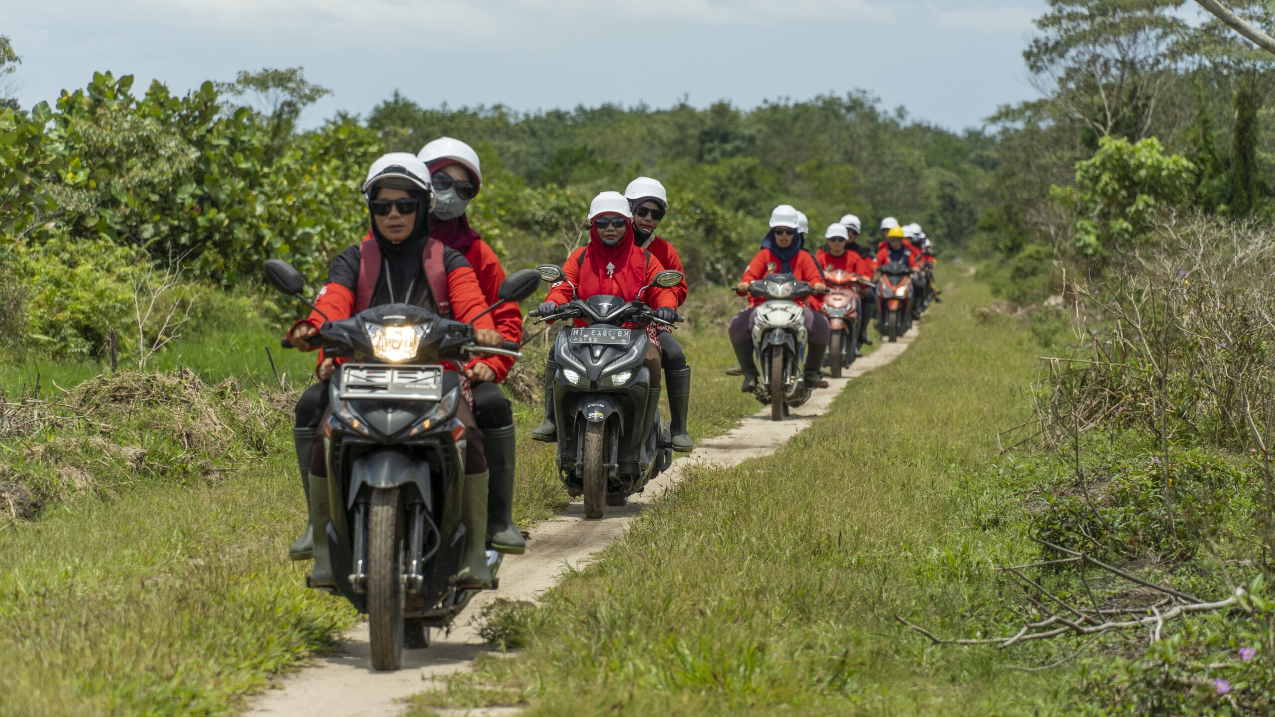 A group of women from the power of mama ride on scooters to patrol the forest