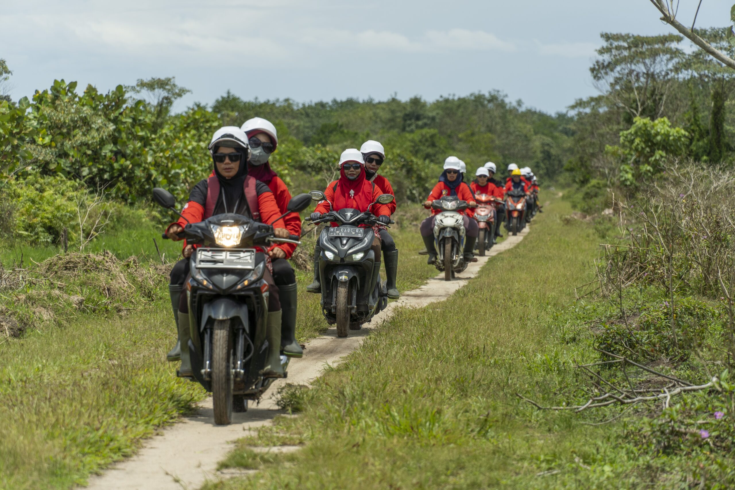 A group of women from the power of mama ride on scooters to patrol the forest