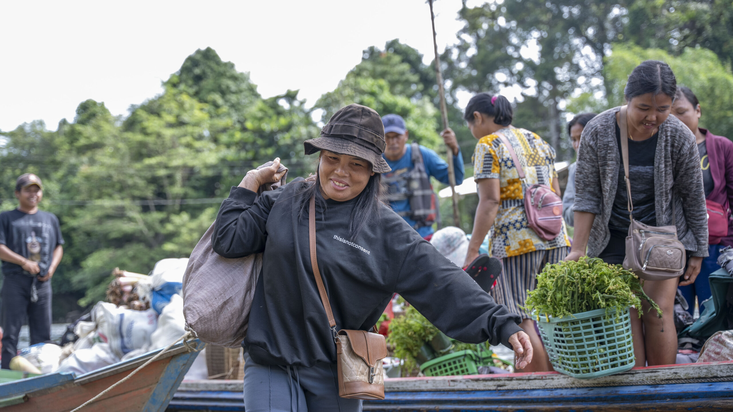 Boat on river in Indonesia filled with villagers taking vegetables to market