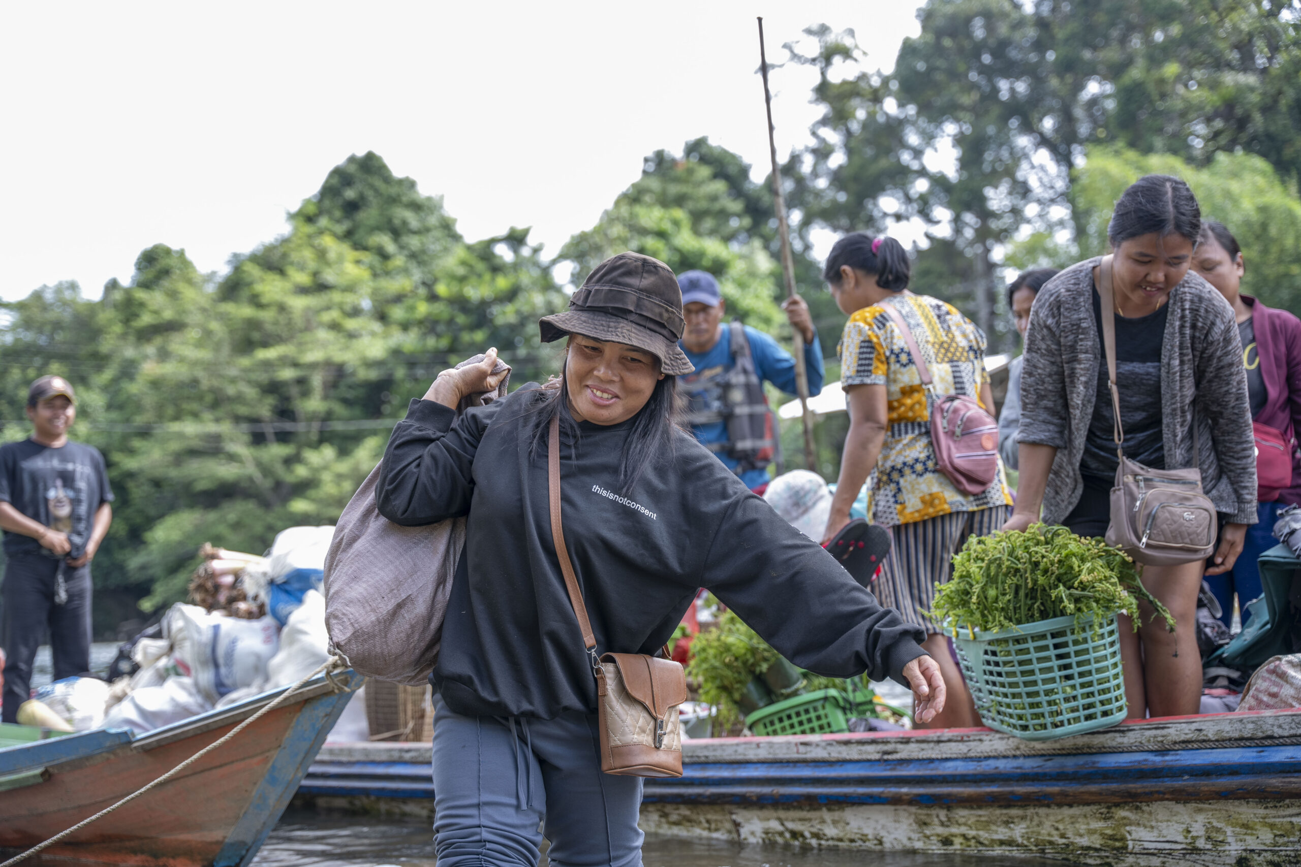 Boat on river in Indonesia filled with villagers taking vegetables to market