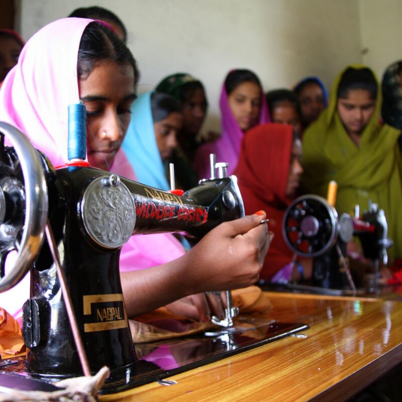 Kalandar woman learning to sew